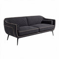 Modern two-seater sofa in dark gray fabric with gold piping details